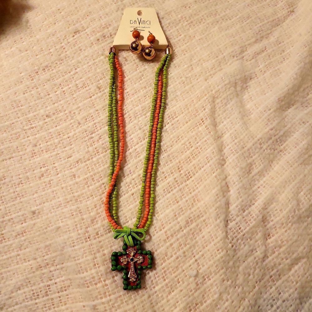 A beaded necklace with a cross attached with leather Swarovski blue crystal